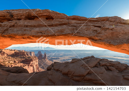 Sunrise glowing under natural stone arch in Utah canyon landscape offers inspiring peaceful serene desert view Sunrise glowing under natural stone arch in Utah canyon landscape offers inspiring peaceful serene desert view 142154703