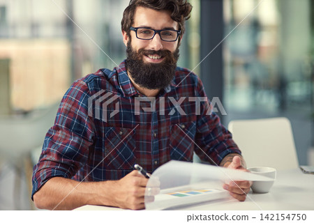 Documents, portrait and writing with designer man in office for artistic project management. Design, paper and smile of happy young employee with beard in creative workplace for proposal development Documents, portrait and writing with designer man in office for artistic project management. Design, paper and smile of happy young employee with beard in creative workplace for proposal development 142154750