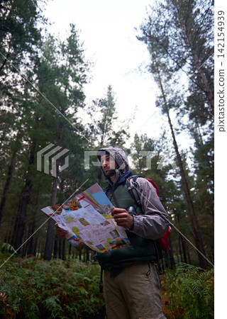 Lost, man and search forest with map as guide to camp in woods and thinking of navigation or direction. Confused, travel and trekking in nature with backpack and plan to location on hiking journey Lost, man and search forest with map as guide to camp in woods and thinking of navigation or direction. Confused, travel and trekking in nature with backpack and plan to location on hiking journey 142154939