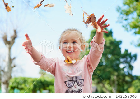 Autumn, leaves and girl play with freedom outdoor and relax on Thanksgiving, holiday or vacation. Happy, child and games in backyard playground, park and hands with leaf from trees in garden or woods Autumn, leaves and girl play with freedom outdoor and relax on Thanksgiving, holiday or vacation. Happy, child and games in backyard playground, park and hands with leaf from trees in garden or woods 142155006