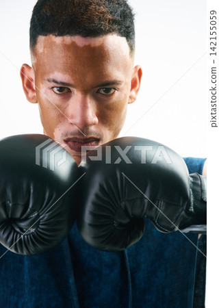 Boxing, fitness and portrait of man in studio with sports, attitude and resilience, never give up and mindset on white background. Face, gym or warrior with training, motivation or vitiligo awareness Boxing, fitness and portrait of man in studio with sports, attitude and resilience, never give up and mindset on white background. Face, gym or warrior with training, motivation or vitiligo awareness 142155059