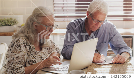 Elderly couple, laptop and kitchen for research, financial budget and online investment for mortgage payment in retirement. Man, woman and serious with tech and paperwork or planning internet banking Elderly couple, laptop and kitchen for research, financial budget and online investment for mortgage payment in retirement. Man, woman and serious with tech and paperwork or planning internet banking 142155069