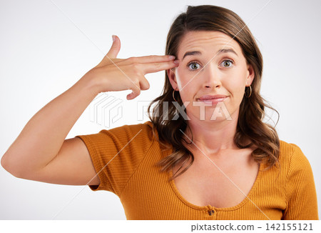 Hand, gun and portrait of frustrated woman in studio for mental health, disaster crisis on white background. Mind, psychology and bored with finger weapon or explosion, threat and overthinking stress Hand, gun and portrait of frustrated woman in studio for mental health, disaster crisis on white background. Mind, psychology and bored with finger weapon or explosion, threat and overthinking stress 142155121