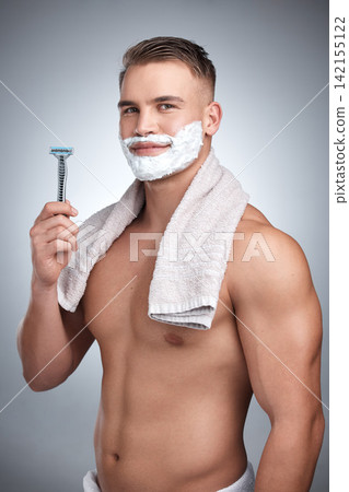 Portrait, man and razor with hair removal in studio for grooming, shaving cream and towel by backdrop. Male person, body and happy with soap for skincare, beard and facial products by grey background 142155122