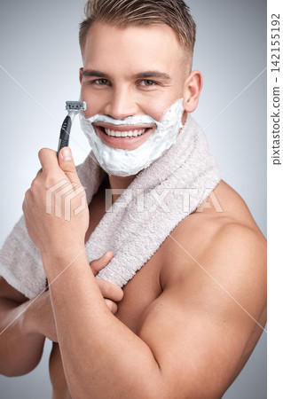 Portrait, happy man and razor for hair removal in studio with grooming, shaving cream and towel by backdrop. Male person, body and soap for skincare, beard and facial products by grey background Portrait, happy man and razor for hair removal in studio with grooming, shaving cream and towel by backdrop. Male person, body and soap for skincare, beard and facial products by grey background 142155192