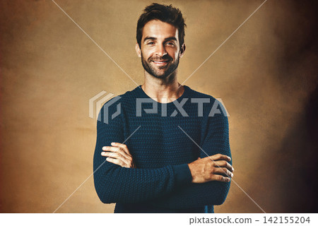 Portrait, man and fashion in studio for confidence for modeling, designer brand and hipster style. Handsome face, smile and model by brown background for winter clothes, cool hair and casting agency Portrait, man and fashion in studio for confidence for modeling, designer brand and hipster style. Handsome face, smile and model by brown background for winter clothes, cool hair and casting agency 142155204