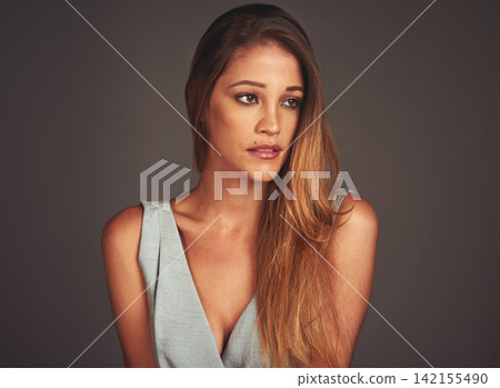 Young, woman and beauty on dark background for fashion, style and pose in backdrop. Female person, confidence and pride in clothes, cosmetics and makeup for salon or haircare in studio or backdrop Young, woman and beauty on dark background for fashion, style and pose in backdrop. Female person, confidence and pride in clothes, cosmetics and makeup for salon or haircare in studio or backdrop 142155490