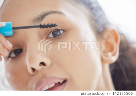 Portrait, makeup and woman with mascara brush in home for skincare, beauty or treatment in bathroom. Apply cosmetics, eyelashes and face of girl with product for morning routine to prepare closeup Portrait, makeup and woman with mascara brush in home for skincare, beauty or treatment in bathroom. Apply cosmetics, eyelashes and face of girl with product for morning routine to prepare closeup 142155506