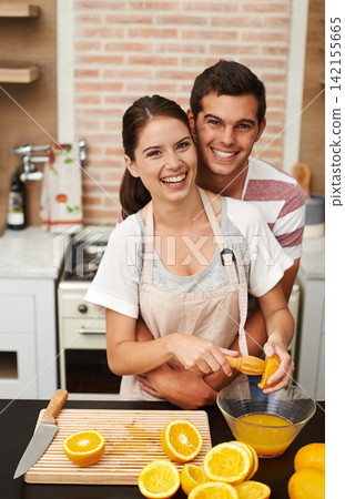 Portrait, couple and hug with orange juice in happy, healthy and wellness for breakfast. Man, woman and cheerful in preparing fruit for nutrition, vitamin c and diet for fresh, squeezed and drink Portrait, couple and hug with orange juice in happy, healthy and wellness for breakfast. Man, woman and cheerful in preparing fruit for nutrition, vitamin c and diet for fresh, squeezed and drink 142155665