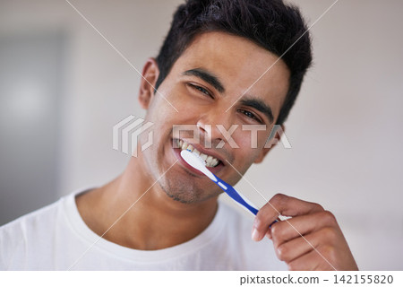 Happy, portrait and man with toothbrush in bathroom for dental hygiene, gum disease and oral care. Health, mouth and face of person brushing teeth for wellness, cleaning and fresh breath in home Happy, portrait and man with toothbrush in bathroom for dental hygiene, gum disease and oral care. Health, mouth and face of person brushing teeth for wellness, cleaning and fresh breath in home 142155820