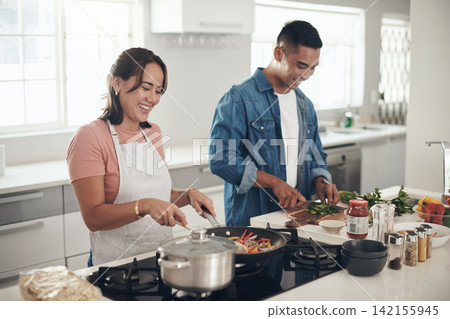 Lunch, cooking and happy couple in kitchen together with healthy food, relationship and bonding in home. Diet, wellness and man helping woman in apartment with nutrition, care and meal prep with love Lunch, cooking and happy couple in kitchen together with healthy food, relationship and bonding in home. Diet, wellness and man helping woman in apartment with nutrition, care and meal prep with love 142155945