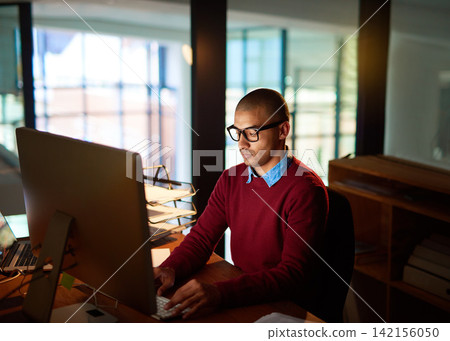 Night, typing and businessman with computer, glasses and planning for online project at networking agency. Research, internet and consultant at desk writing article, review or report in dark office 142156050