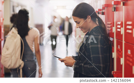 High school, locker and phone with student girl in hallway for communication, networking or text message. App, social media and smile with happy learner or pupil in corridor for education and study High school, locker and phone with student girl in hallway for communication, networking or text message. App, social media and smile with happy learner or pupil in corridor for education and study 142156094
