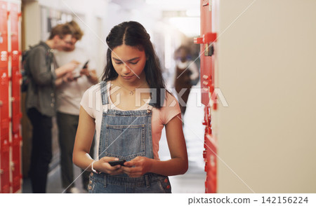 High school, student and hallway with cellphone texting by lockers for education, scholarship or communication. Girl, smartphone and building corridor for academic learning or campus, course or app High school, student and hallway with cellphone texting by lockers for education, scholarship or communication. Girl, smartphone and building corridor for academic learning or campus, course or app 142156224