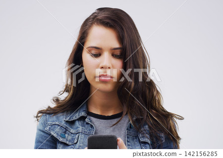 Girl, student and phone for notification in studio, reading and university website for application. Woman, social media and internet for survey, communication and online dating app on gray background 142156285