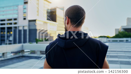 Back, training and man thinking in city for running, cardio workout or endurance exercise. Lens flare, sports and athlete for parkour preparation, fitness or thoughtful on rooftop in urban town Back, training and man thinking in city for running, cardio workout or endurance exercise. Lens flare, sports and athlete for parkour preparation, fitness or thoughtful on rooftop in urban town 142156300