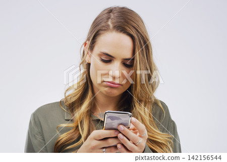 Woman, depression and sad with smartphone for social media post in grey background, technology and emotion. Girl, mental health and stress for marriage, anxiety and browsing on web app or internet Woman, depression and sad with smartphone for social media post in grey background, technology and emotion. Girl, mental health and stress for marriage, anxiety and browsing on web app or internet 142156544