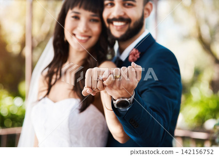 Happy couple, marriage and hands with wedding rings for engagement, proposal or outdoor ceremony. Married man, woman and bride, groom or lovers with partnership, relationship or commitment at alter Happy couple, marriage and hands with wedding rings for engagement, proposal or outdoor ceremony. Married man, woman and bride, groom or lovers with partnership, relationship or commitment at alter 142156752