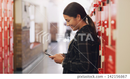 High school, teenager and hallway with cellphone texting by lockers for education, scholarship or communication. Girl, smartphone and building corridor for academic learning or campus, course or app High school, teenager and hallway with cellphone texting by lockers for education, scholarship or communication. Girl, smartphone and building corridor for academic learning or campus, course or app 142156867