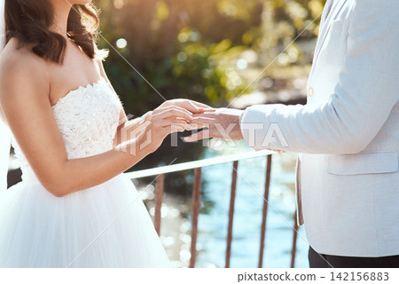 Couple, love and wedding ring in outdoors, jewelry and symbol for promise of loyalty or commitment. People, fingers and balcony for partnership, support and trust in marriage or relationship Couple, love and wedding ring in outdoors, jewelry and symbol for promise of loyalty or commitment. People, fingers and balcony for partnership, support and trust in marriage or relationship 142156883
