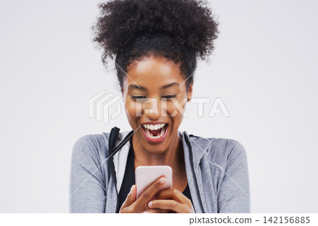 Woman, athlete and phone surprise in studio, victory notification and lottery success. Black model, wow and excited for fitness goals on white background, promotion email with gym discount and app Woman, athlete and phone surprise in studio, victory notification and lottery success. Black model, wow and excited for fitness goals on white background, promotion email with gym discount and app 142156885
