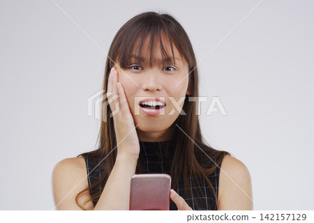 Asian woman, portrait and phone surprise for news in studio, salary increase and lottery success. Female person, shock and offer for bonus on white background, promotion email and discount deal Asian woman, portrait and phone surprise for news in studio, salary increase and lottery success. Female person, shock and offer for bonus on white background, promotion email and discount deal 142157129