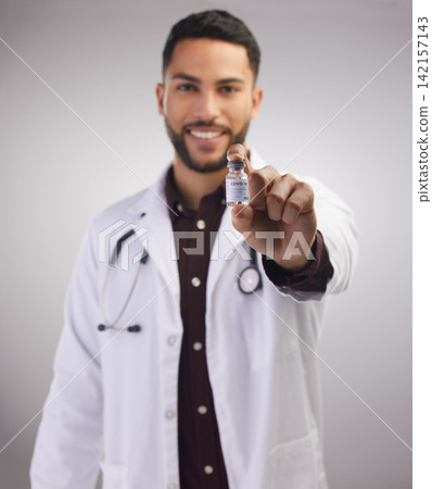 Portrait, doctor and holding vaccine in studio for healthcare, medical and man in lab coat by grey background. Professional male person, stethoscope and bottle in clinic with pride for medicine 142157143