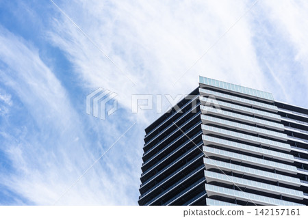 Low angle view of modern residential building with balconies under cloudy sky in Fukuoka, Japan Low angle view of modern residential building with balconies under cloudy sky in Fukuoka, Japan 142157161