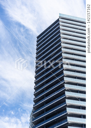 Low angle view of modern residential building with balconies under cloudy sky in Fukuoka, Japan Low angle view of modern residential building with balconies under cloudy sky in Fukuoka, Japan 142157162