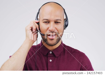 Man, thinking and studio with headphones for customer service or call center, smile for communication. Male person, white background and microphone with happiness for chat, telemarketing or working Man, thinking and studio with headphones for customer service or call center, smile for communication. Male person, white background and microphone with happiness for chat, telemarketing or working 142157403