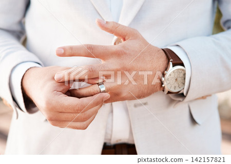 Man, groom and wedding ring in outdoors, jewelry and symbol for promise of loyalty or commitment. Male person, fingers and icon for love or partnership, support and trust in marriage or relationship 142157821