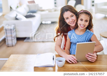 Mother, girl and tablet in portrait at table, online class and remote learning or education in home. Daughter, mama and streaming cartoon or app for development, bonding and support in childhood Mother, girl and tablet in portrait at table, online class and remote learning or education in home. Daughter, mama and streaming cartoon or app for development, bonding and support in childhood 142157857