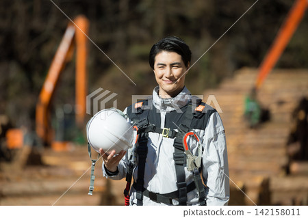 Worker wearing a full harness Worker wearing a full harness 142158011