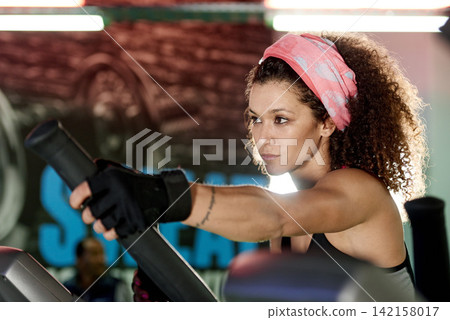 Workout, gym or woman on stepper machine for cardio training, body fitness or energy for endurance. Development, exercise club or healthy sports person on bicycle for cycling, challenge or wellness 142158017