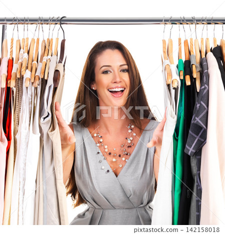 Portrait, happy woman and clothes rack in studio at closet isolated on a white background for commerce or shopping. Smile, face and wardrobe for fashion, retail or customer excited for sales discount Portrait, happy woman and clothes rack in studio at closet isolated on a white background for commerce or shopping. Smile, face and wardrobe for fashion, retail or customer excited for sales discount 142158018