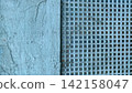 Grunge background with weathered blue textured wall and perforated metal grid 142158047