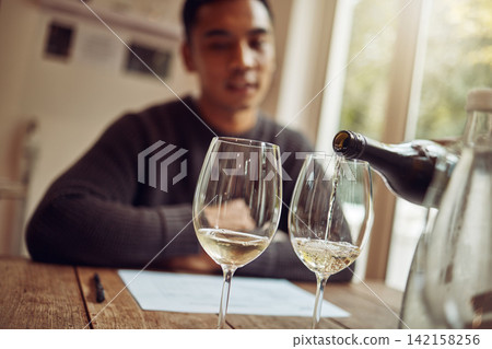 Wine glasses, alcohol and man at vineyard restaurant for tasting, celebration or party for dining. Winery, bottle and male person with luxury alcohol champagne by table for dinner, banquet or event. Wine glasses, alcohol and man at vineyard restaurant for tasting, celebration or party for dining. Winery, bottle and male person with luxury alcohol champagne by table for dinner, banquet or event. 142158256
