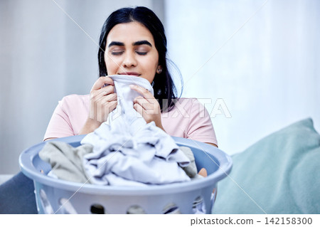 Fresh, laundry and woman smell clothes on sofa for washing, hygiene and spring cleaning in apartment. Female person, fabric and cleaner in home for routine, care and service in living room Fresh, laundry and woman smell clothes on sofa for washing, hygiene and spring cleaning in apartment. Female person, fabric and cleaner in home for routine, care and service in living room 142158300