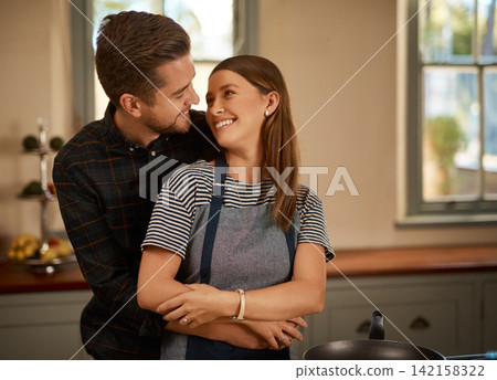 Love, hug and couple in kitchen for cooking, brunch or bonding with care or security at home. Food, diet and nutrition in house for breakfast, balance and meal prep with romance, gratitude or support Love, hug and couple in kitchen for cooking, brunch or bonding with care or security at home. Food, diet and nutrition in house for breakfast, balance and meal prep with romance, gratitude or support 142158322
