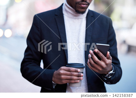 Black businessman, fashion and hands with smartphone and coffee for connection, travel or work break. Formal, male person and technology with drink for commute to workplace with communication Black businessman, fashion and hands with smartphone and coffee for connection, travel or work break. Formal, male person and technology with drink for commute to workplace with communication 142158387