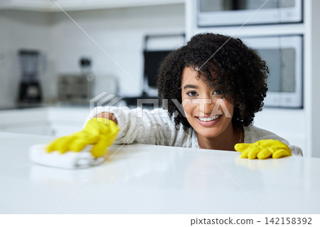 Cleaner, portrait and happy woman in kitchen of home for hygiene, countertop or housekeeping. Cloth, table and face of female maid in apartment for cleaning domestic work, task or wipe surface Cleaner, portrait and happy woman in kitchen of home for hygiene, countertop or housekeeping. Cloth, table and face of female maid in apartment for cleaning domestic work, task or wipe surface 142158392