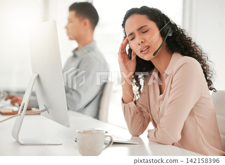 Stress, headache and woman call center consultant with computer in office with burnout for crm. Migraine, exhausted and female with headset for technical support, telemarketing or customer service. Stress, headache and woman call center consultant with computer in office with burnout for crm. Migraine, exhausted and female with headset for technical support, telemarketing or customer service. 142158396