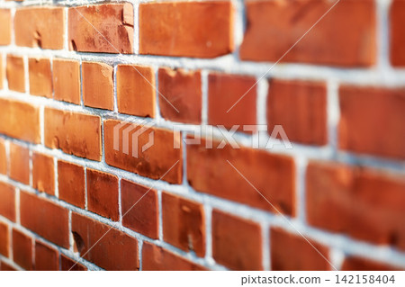 Building, pattern and closeup of brick wall in city for texture, background and design of exterior structure. Architecture, construction and surface of material, concrete and cement for decoration 142158404