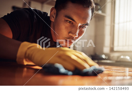 Kitchen counter, wipe and man with gloves for cleaning, safety and surface with dust at home. Housework, male person or professional cleaner with cloth or fabric for housekeeping, service or hygiene Kitchen counter, wipe and man with gloves for cleaning, safety and surface with dust at home. Housework, male person or professional cleaner with cloth or fabric for housekeeping, service or hygiene 142158493