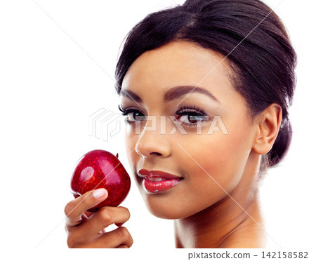 Beauty, apple and portrait of woman in studio with organic, fresh and natural snack for face. Cosmetic, glow and female person with fruit for facial cosmetology routine isolated by white background Beauty, apple and portrait of woman in studio with organic, fresh and natural snack for face. Cosmetic, glow and female person with fruit for facial cosmetology routine isolated by white background 142158582