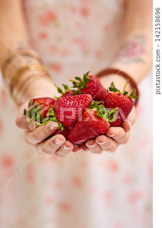 Bunch , strawberries and woman hands as a vegetarian for healthy, organic and balanced diet by eating nutritious snacks. Person, fresh and natural ingredients with vitamin from farming plantation Bunch , strawberries and woman hands as a vegetarian for healthy, organic and balanced diet by eating nutritious snacks. Person, fresh and natural ingredients with vitamin from farming plantation 142158696