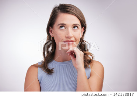 Face, idea and thinking with woman problem solving in studio on gray background for inspiration. Future, planning and vision with confused person looking up for opportunity, solution or question 142158817