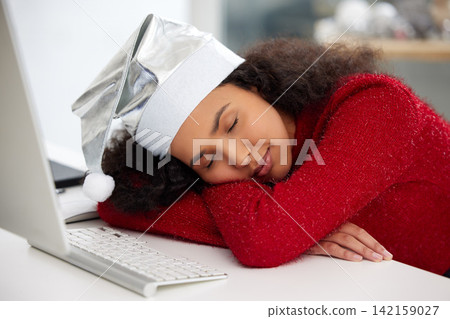 Woman, desktop and Christmas hat with fatigue or sleeping in work from home on table for holiday. Female person, tired and rest in office with technology in house for freelance, copywriting or job Woman, desktop and Christmas hat with fatigue or sleeping in work from home on table for holiday. Female person, tired and rest in office with technology in house for freelance, copywriting or job 142159027