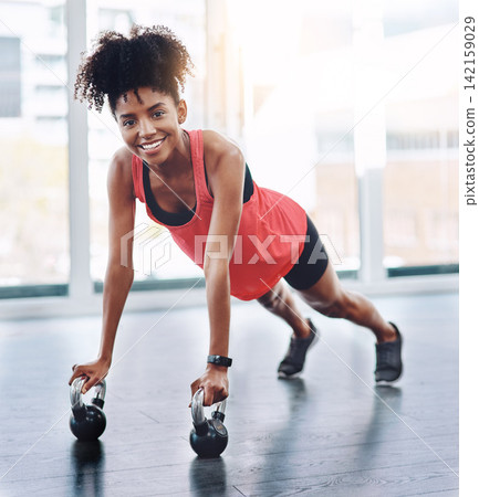 Black woman, push up and kettlebell in gym portrait for fitness, strong arms and core in workout. Female person, training and body challenge for bodybuilder, resilience and lifting routine for health Black woman, push up and kettlebell in gym portrait for fitness, strong arms and core in workout. Female person, training and body challenge for bodybuilder, resilience and lifting routine for health 142159029