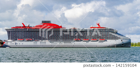 View of luxury liner. Ship leaving Miami beach port. Luxury sea vacation. Cruise ship vacation. Majestic cruise ship in vacation summer. Cruise ship vacation and travel at sea. Relaxation facilities View of luxury liner. Ship leaving Miami beach port. Luxury sea vacation. Cruise ship vacation. Majestic cruise ship in vacation summer. Cruise ship vacation and travel at sea. Relaxation facilities 142159104